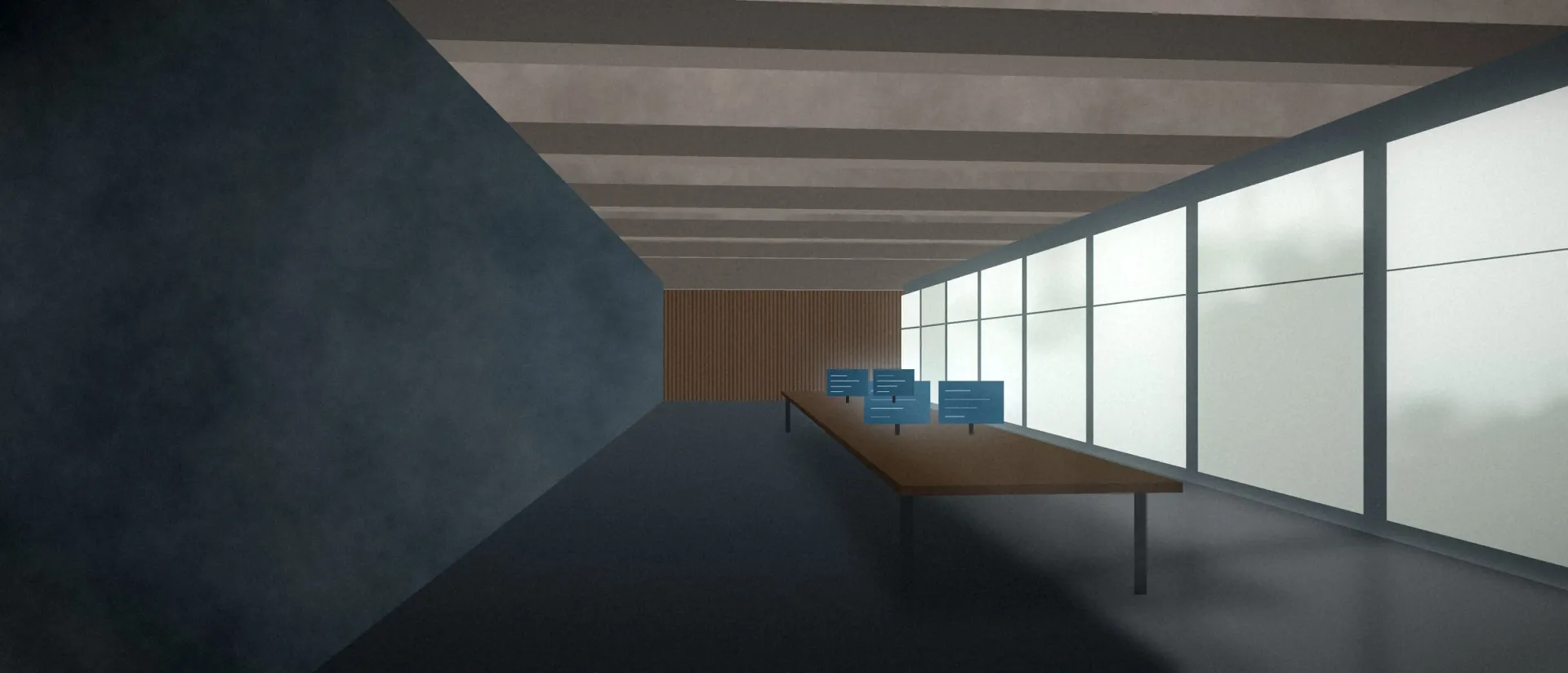 Espaço de trabalho com teto de concreto, janelas altas e uma mesa longa com monitores acesos